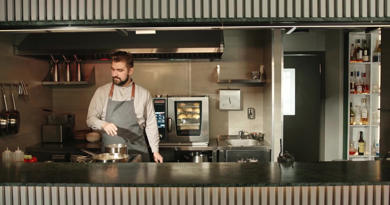 A chef working in an open kitchen